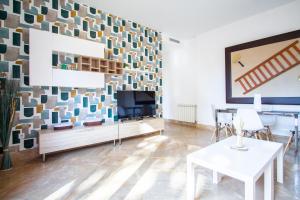 a living room with a fireplace and a tv at Apartamentos Villablino Arturo Soria in Madrid