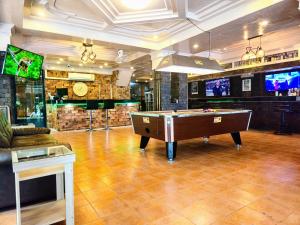 a room with a pool table and a bar at Rock Shore Patong in Patong Beach