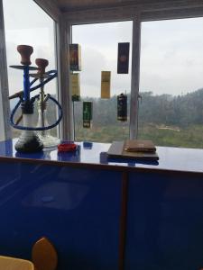 a desk with a view of a window at Balthali himalaya view point restro in Panaoti