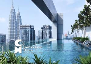a view of the kuala lumpur city skyline from a swimming pool at Royce Residence Kuala Lumpur by Collective Haus in Kuala Lumpur