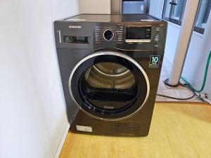 a washing machine is sitting in a room at BA Stay in Suwon