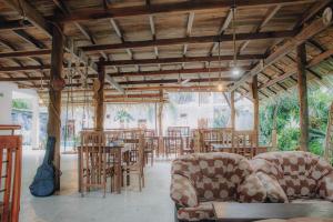 a restaurant with chairs and tables in a room at Shell Resort in Arugam Bay