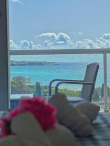 a room with a view of the ocean and a chair at 3 Bedroom Coral Bay Panorama Seaview Villa Pool in Coral Bay