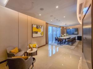 a living room and dining room with a table and chairs at Boutique Living - Opera Grand in Dubai