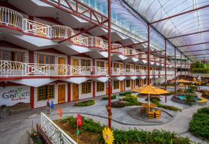 arium of a building with a courtyard with a garden at Kea Garden Guest House in Brinchang