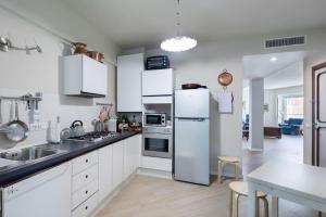 a kitchen with white cabinets and a white refrigerator at Appartamento con vista sul mare!!! 008055-LT-0380 in Sanremo