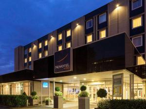 a hotel building with a sign on the front of it at Novotel Maastricht in Maastricht