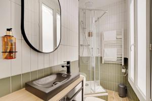 a bathroom with a sink and a shower at Maison Urbaine in Paris