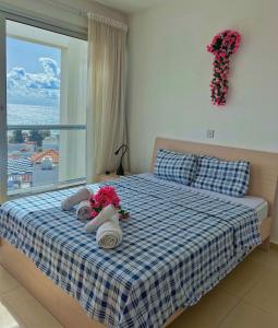 a child laying on a bed with flowers on it at 3 Bedroom Coral Bay Panorama Seaview Villa Pool in Coral Bay