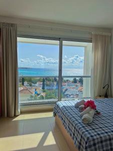 een slaapkamer met een bed en een groot raam bij 3 Bedroom Coral Bay Panorama Seaview Villa Pool in Coral Bay