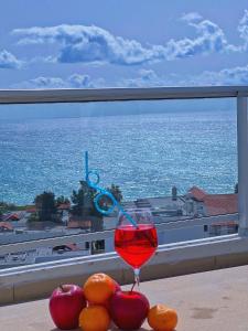 een glas rode wijn op een tafel met fruit bij 3 Bedroom Coral Bay Panorama Seaview Villa Pool in Coral Bay