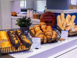 a display of pastries and bread on a shelf in a store at ibis budget Epinal in Épinal