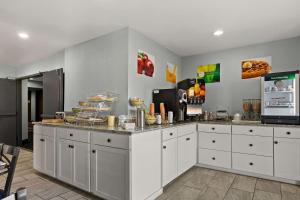 a kitchen with white cabinets and a counter at Quality Inn in Lavonia