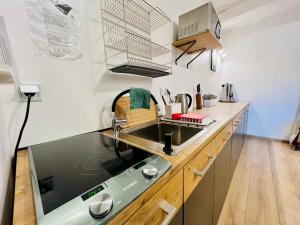 a kitchen with a sink and a counter top at Hostel Pod Gromadzyniem in Ustrzyki Dolne