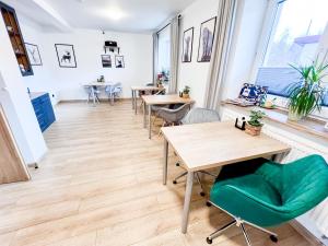a room with tables and chairs and windows at Hostel Pod Gromadzyniem in Ustrzyki Dolne