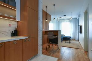 a kitchen and dining room with a table and chairs at Apartment Sanja in Novi Sad