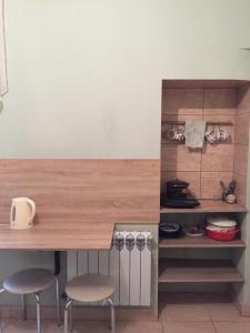 a kitchen with two stools and a wooden counter top at М.Арнаутская 33 in Odesa