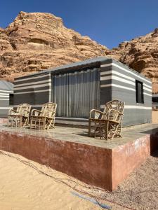 a group of chairs sitting on top of a building at Wadi Rum alsultan Camp in Wadi Rum