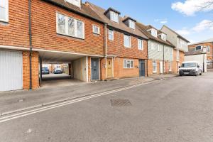 an empty street in front of a brick building at The Chaucer - Stylish City Centre Gem - Sleeps 7 in Kent