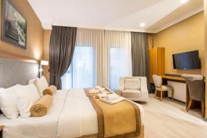 a hotel room with a large bed and a desk at Orange Sisli in Istanbul
