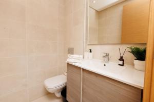 a bathroom with a toilet and a sink at Central Charm: 1-Bed Apartment in Hay Riad in Rabat