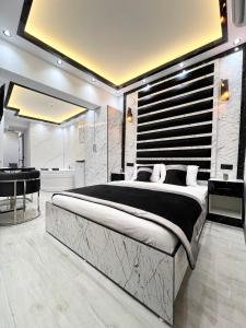 a bedroom with a large bed and a bath room at Taksim Larissa hotel suites in Istanbul
