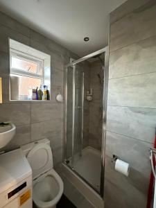 a bathroom with a shower and a toilet and a sink at Smart Cosy/Small Double Room in Oakridge Road Bromley in Lewisham