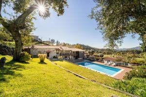 an estate with a swimming pool in a yard at Casa do Souto Vieira do Minho - Casa Rural com piscina by House and People in Lugar