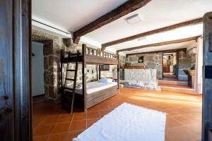 a bedroom with a bunk bed in a room at Casa do Souto Vieira do Minho - Casa Rural com piscina by House and People in Lugar +43 photos