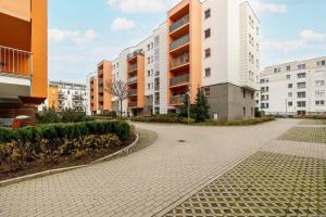 an empty street in a city with buildings at Wilczak Spacious Apartment with FREE GARAGE Poznań by Noclegi Renters in Poznań