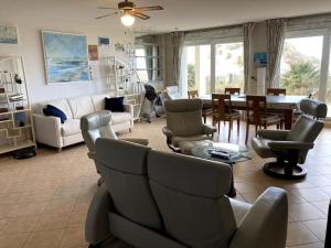 a living room with a couch and chairs and a table at Appartement La plage in Berck-sur-Mer