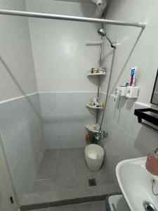 a bathroom with a shower and a toilet and a sink at Near Mactan Airport and Indiana Aerospace University, Lapu Lapu City in Pajak