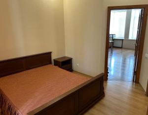 a bedroom with a bed and a door to a hallway at Апартаменти 3-кімнатні, м. Майдан Незалежності in Kyiv