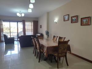 a dining table and chairs in a living room at Heaven Heights - Fully Furnished Air Con Apartment in Rose Hill