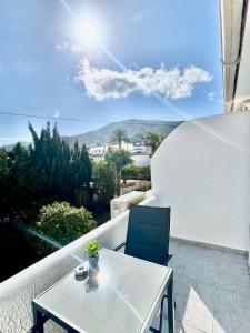 a white table and chairs on a balcony with a view at Perseo by Albir Proper Properties in Albir