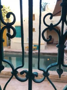 a fence with a pool of water behind it at Dar Kenza in Djerba
