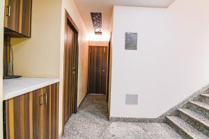 a kitchen with a staircase leading to a hallway at FabExpress Scholer Motel in Kolkata