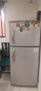 a white refrigerator with magnets on top of it at Apartamento de 2 habitaciones en Robledo a 20 minutos del centro in Medellín
