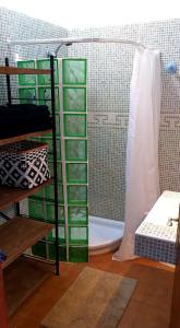 a shower with green shelves in a room at Sunset Terrace in La Oliva