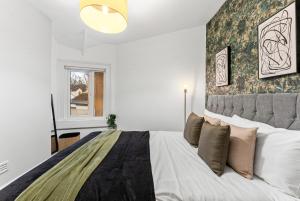 a bedroom with a large bed and a window at Deluxe Central Bath House - Sleeps 7 in Bath