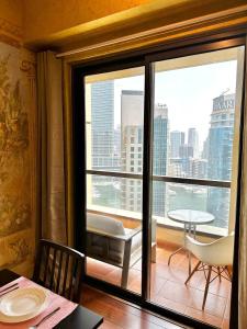 a room with a balcony with a view of a city at Sunkissed holiday homes Stunning marina view 4BR plus maid room on JBR beach near mall in Dubai