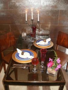 a dining room table with two plates and candles at Het Boetje in Lagoa