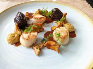 a plate of food with potatoes and vegetables on it at Hotel Le Lion D'Or et Restaurant La Table Du Lion in Bayeux