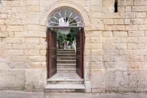 an entrance to a stone building with a door and stairs at Fatata Suites in Lecce
