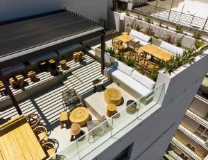 an overhead view of a building with tables and chairs at ONOMA Hotel in Thessaloniki