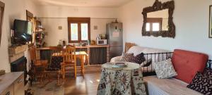 a living room with a couch and a table at Cortijo Las Pilares in Granada