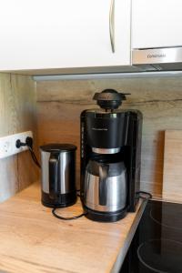 a coffee maker sitting on top of a kitchen counter at Bahnhöfle Ferienhaus in Stubersheim +13 photos
