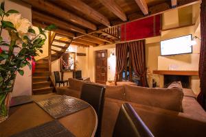 a living room with a couch and a table at Monte Bianco Villas in Arachova