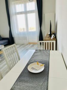 a plate on a table with a knife and fork at Danube Panorama apartments in Budapest