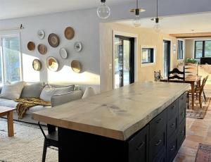 a kitchen and living room with a large counter top at West Branch 75, Waterville Valley in Waterville Valley